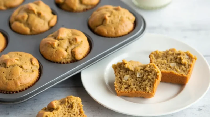 Close-up of 5-ingredient protein muffins in a muffin tin with some on a white plate.